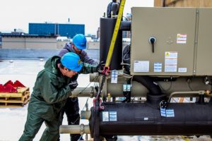 two contractors working on commercial hvac unit