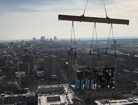 boiler systems and pump skid hanging from crane