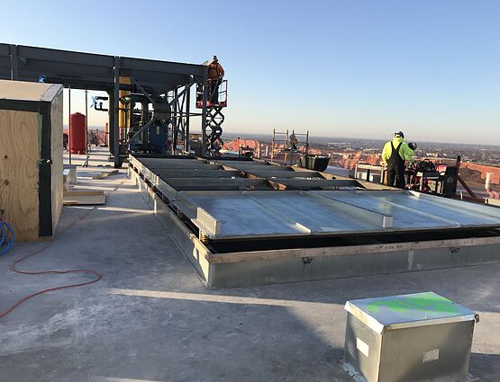 contractors installing hvac systems on rooptop
